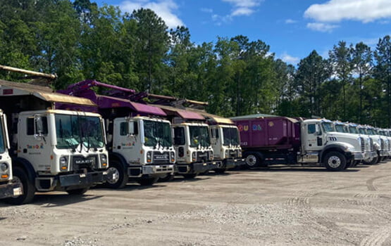 Cropped view showing line of Trash Gurl trucks.